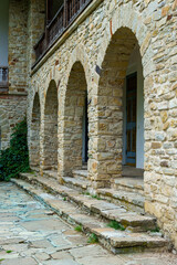 Naklejka premium view of the facade of an old house with a porch and arches