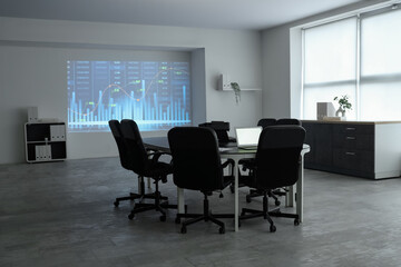 Interior of data scientist's office with workplace, laptops and diagrams projection on wall