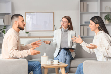 Fototapeta premium Family mediator talking with couple in office