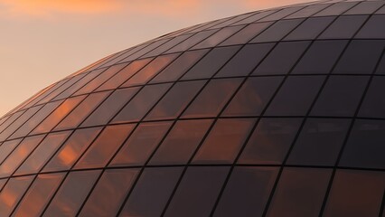 Modern Architecture Glass Facade Reflecting Sunset Sky.
