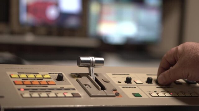 Hand on Analogue Television Switcher Mixer in Control Room of TV Station From 1990's