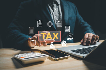 Businessman calculating digital tax using laptop, calculator, and smartphone with virtual tax icons, representing finance management, accounting, taxation system, and online financial compliance.