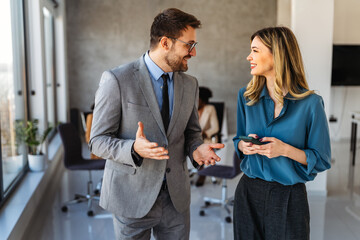Group of young business people working as a team and communicating in corporate office
