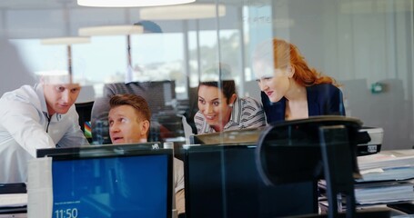 Four professionals are collaborating around monitors in flat design business office with glass wall