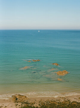 Far away sailboat in the atlantic ocean