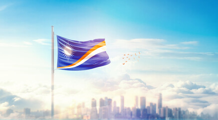 Marshall Islands flag wavering in beautiful clouds with building skyline. The flag with drone shot...