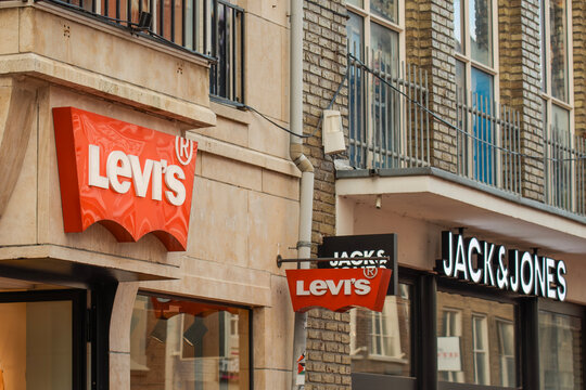 Popular outdoor store signs showcasing casual fashion options in a lively shopping district  levis jack and jones