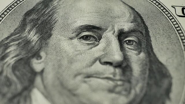 100 dollar bill, focusing on Benjamin Franklin portrait. Deposit money used in banking and financial systems. Currency used as medium of exchange in domestic and international markets