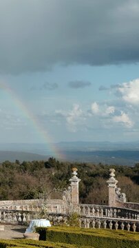 Rainbow appearing over a scenic balcony in bomarzo, italy. Action