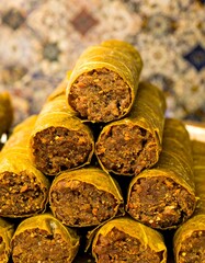 Stacked grape leaves, filled with a brown mixture