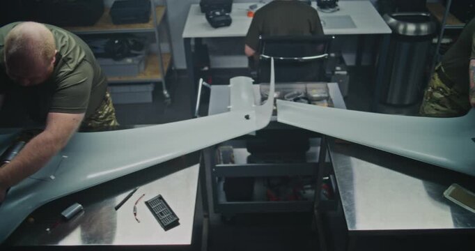Well Lit, Organized Drone Factory Features Several Stations Where Engineers Assembling Large UAVs. Concept of Assembly For UAV, Streamlined, Systematic Approach to Modern Defense Production. Top View.