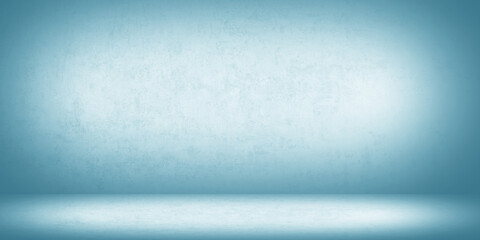 Empty seamless studio background with light blue gradient. Smooth textured wall and floor are...
