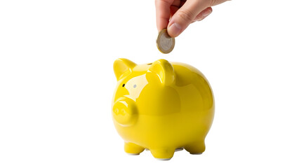 A hand dropping a coin into a bright yellow piggy bank on a black background