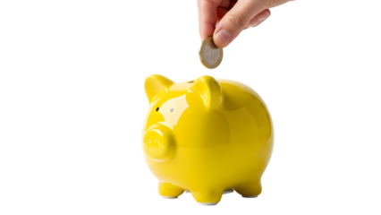 A hand dropping a coin into a bright yellow piggy bank on a black background