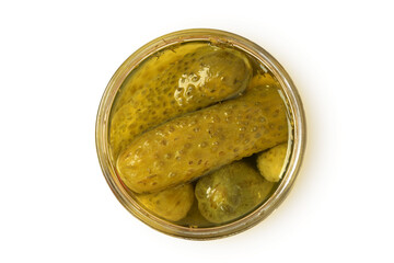 Top view of pickled cucumbers in glass jar on white background