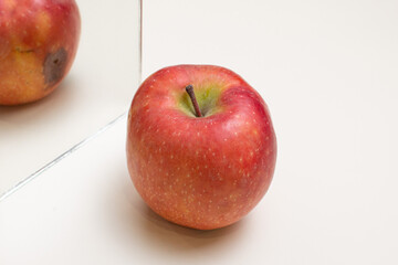 Conceptual photo of a perfect apple vs rotten mirror image