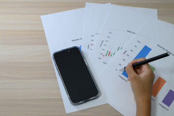 Business analysis using documents and smartphone on desk