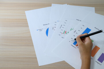 Business person writing on document with smartphone