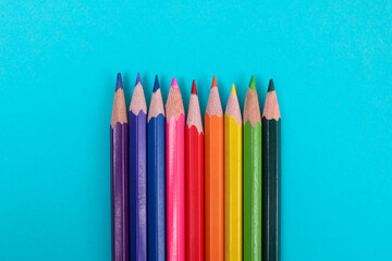 Vibrant Colored Pencils Lined up Against Bold Blue Background