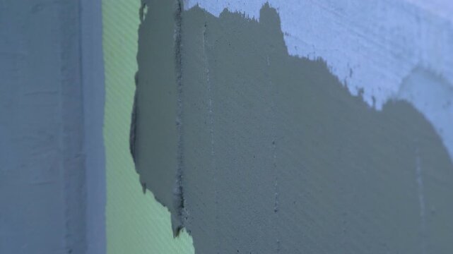 Installed styrofoam insulation sheets on building wall. Vapour barrier for thermal wall insulation. Exterior cladding. Construction site of building family house. External wall insulation system