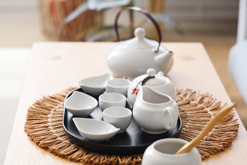 White Asian tea set on table in living room, closeup