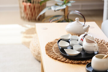 White Asian tea set on table in living room, closeup