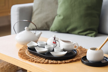 White Asian tea set on table in living room, closeup
