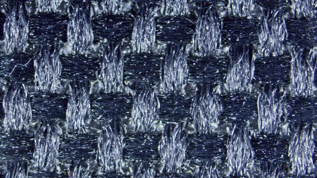 Close-up of woven black fabric fibers under microscope