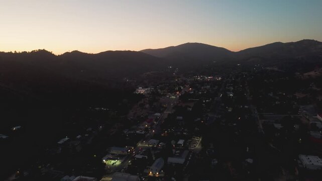 Drone shot of Mariposa, California and hills in the background during golden hour