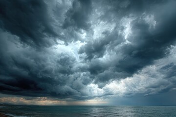 Obraz premium Celestial Canvas: A vast, dramatic canvas of turbulent clouds dominates the seascape, creating an atmosphere of impending weather. capturing the awe-inspiring beauty of nature's forces