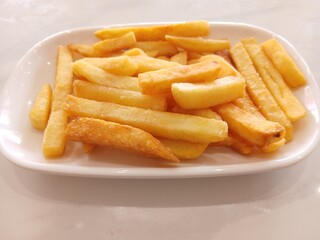 Delicious french fries in plate isolated on white background