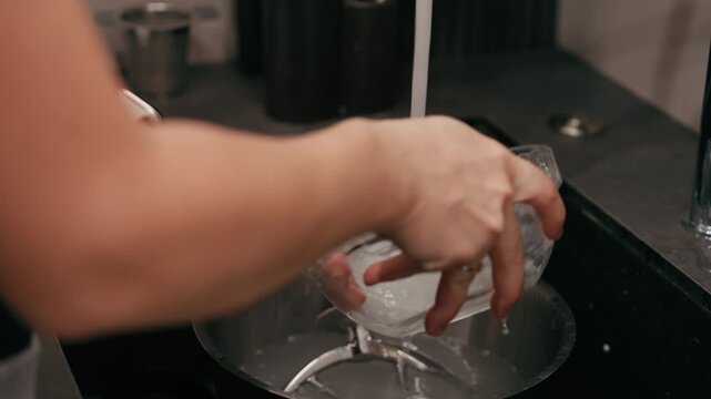 Hands engaged in mindful sourdough baking process, washing tools and bowls, showcasing textures and natural ingredients, camera follows the action closely