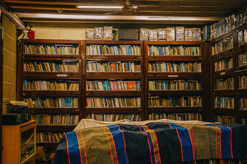Mumbai, India Vintage library interior with old wooden bookshelves filled with worn books. A warm, nostalgic atmosphere highlighting traditional literature and classic reading spaces.
