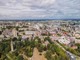 Naklejka premium Bristol UK: 28th July 2025: Breathtaking drone view of Cabot Tower surrounded by lush greenery of Brandon Hill park. With University of Law and city in background