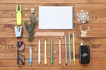 Stationery supplies with Christmas decor on wooden background
