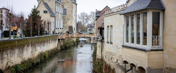 Historic city centre canal Dutch town Valkenburg, The Netherlands, street scene commerce and architecture tourist destination wide angle