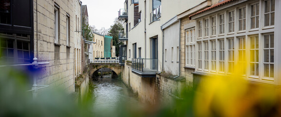 Historic city centre canal Dutch town Valkenburg, The Netherlands, street scene commerce and architecture tourist destination wide angle