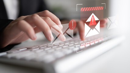 Capture of hands typing on a keyboard with visual email alerts. Represents themes of communication, urgency, and cybersecurity in a modern workplace setting. Gantry
