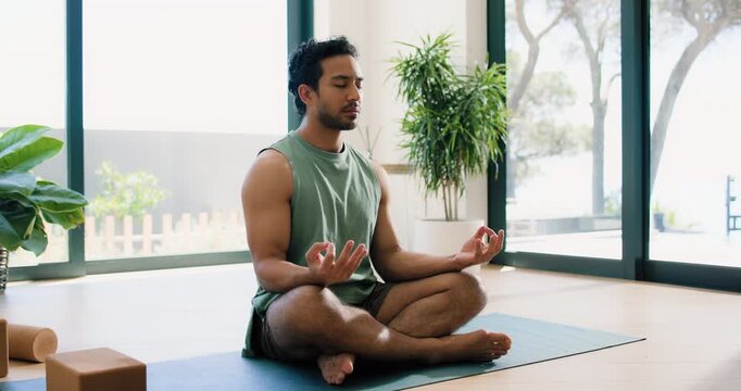 Exercise, meditation and yoga with man in home studio for balance, inner peace or mindfulness. Fitness, relax and zen with yogi person in apartment for holistic health, lotus pose or wellness routine