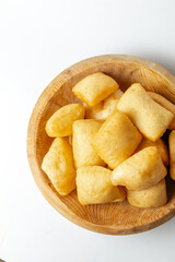 Crispy, fluffy homemade baursaki served in a handcrafted bowl - perfect for cultural cuisine branding, heritage food visuals or global snack storytelling.