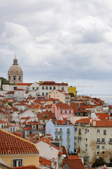 View over the red-tiled roofs and colourful facades of the old town of Lisbon, Portugal.
