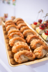 Crispy handcrafted pastries in neat rows - perfect for upscale events, comfort food branding or global cuisine visuals.