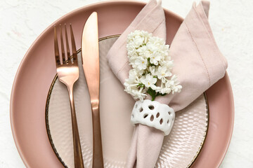 Beautiful table setting with lilac flowers on white background