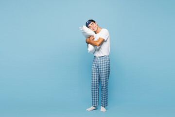 Full body calm young sleepy man he wear pyjamas jam sleep eye mask rest relax at home hold in hand...