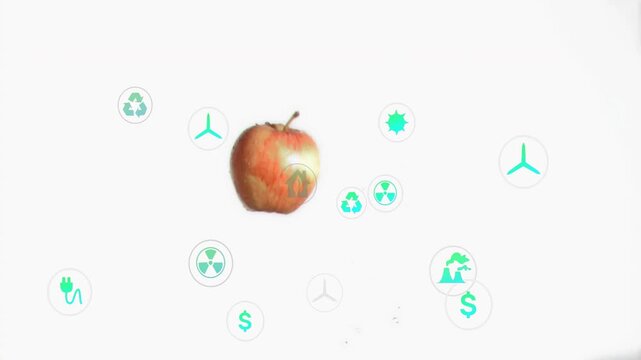 Red apple rising and rotating, causing teal icons to appear and multiply beneath for energy finance