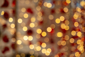 Abstract golden bokeh lights with soft red festive holiday celebration background 