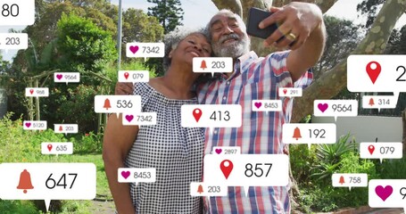 Senior couple posing in garden, man raising phone sharing and causing social badges growing fading - Powered by Adobe