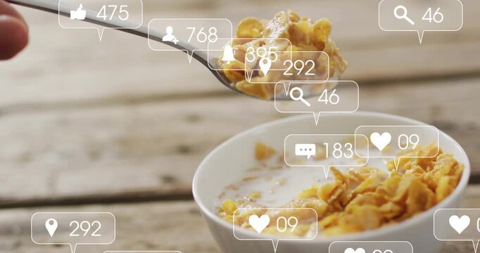 White bowl cornflakes milk on wood table, hand scooping, first lift causing overlays showing reach