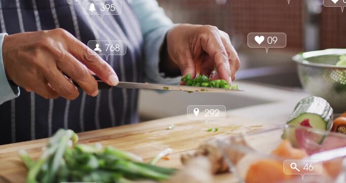 Senior cook chopping greens on board, transferring into bowls, sparking social icons for meal prep