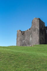 The ruin of Carreg Cennen Castle sited on a high rocky outcrop in Carmarthenshire, Wales on a sunny day